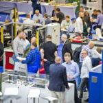 Rozmowy biznesowe przy stoiskach z technologiami przemysłowymi na targach ITM INDUSTRY EUROPE.